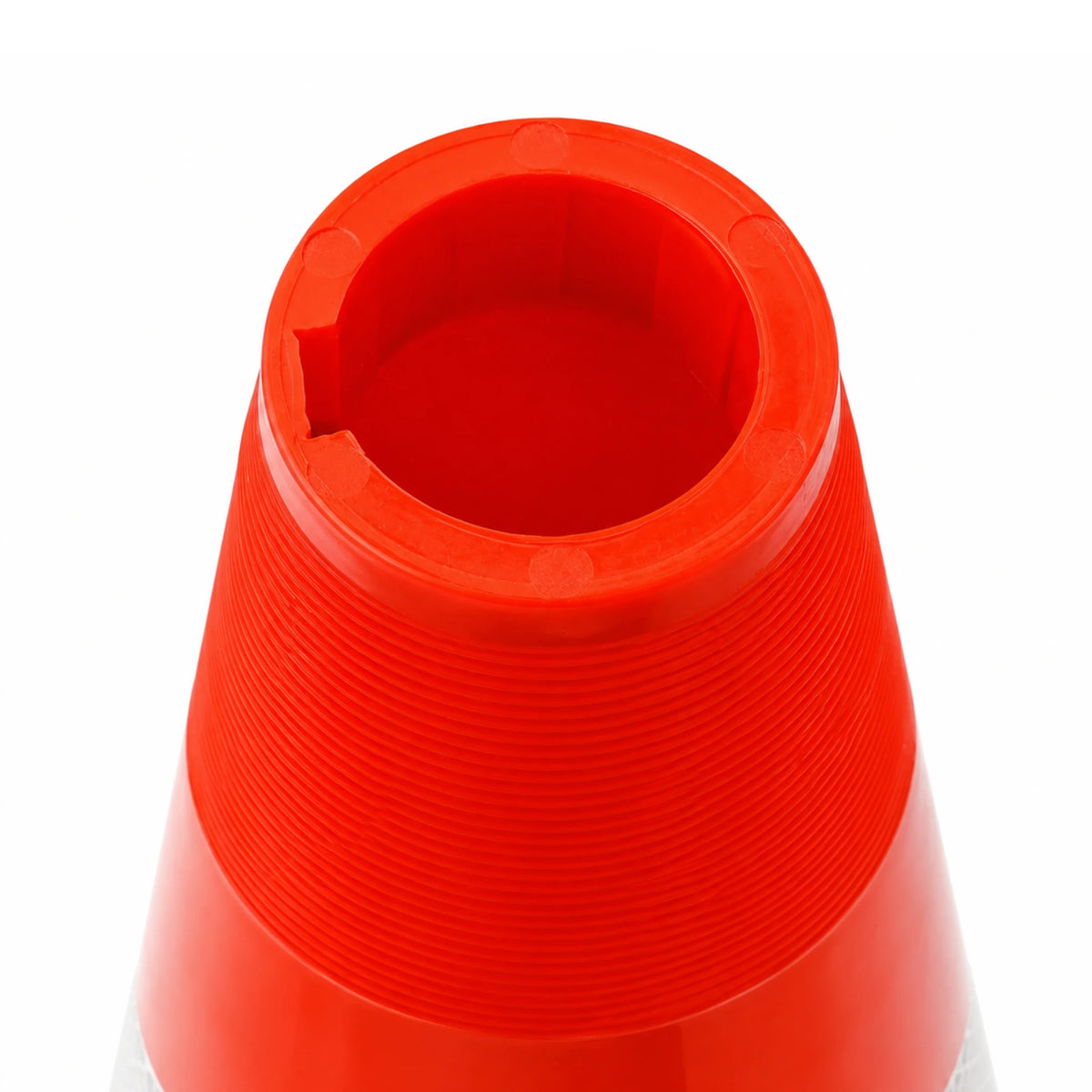 Close-up of a red traffic cone on a white background