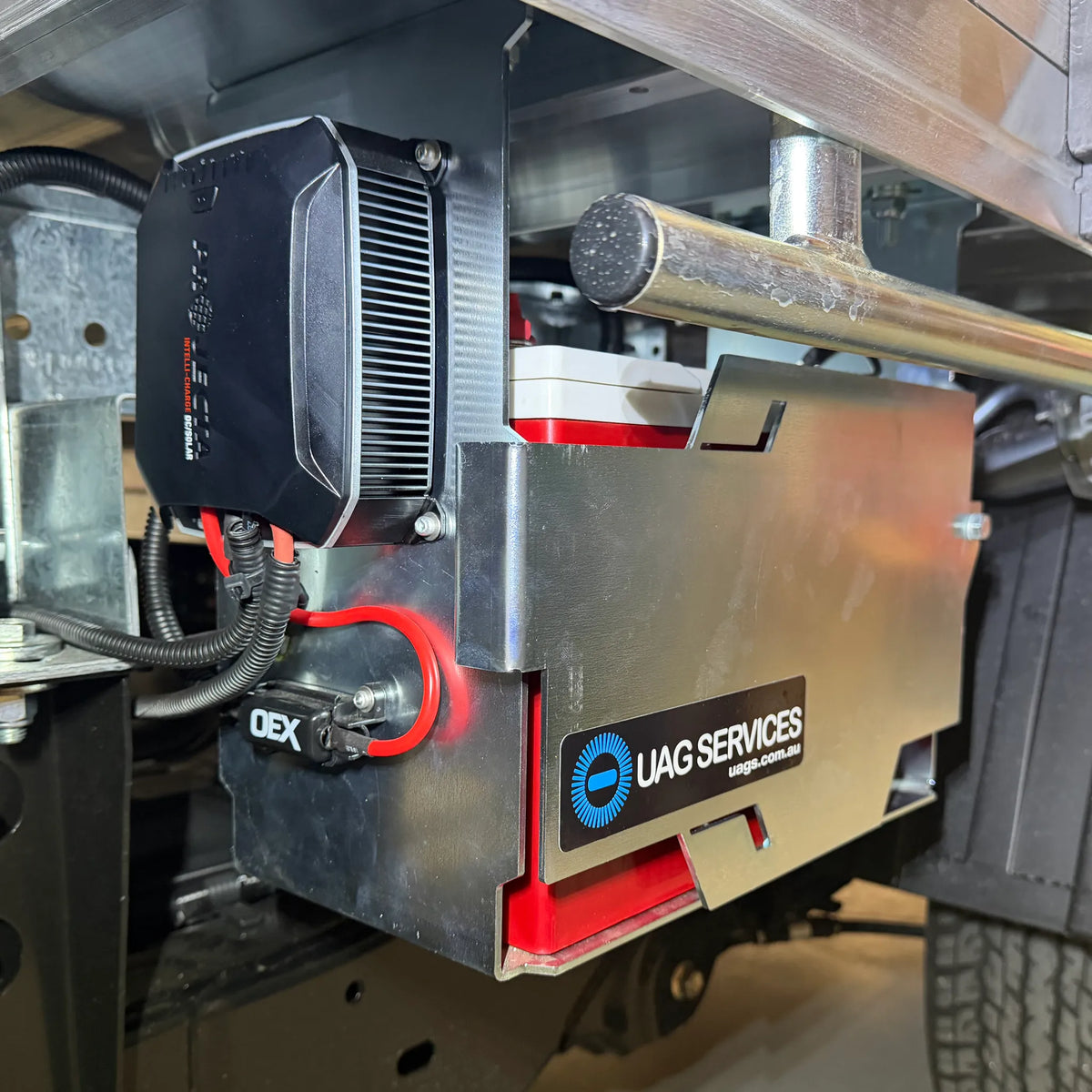 Close-up of a DC to DC Charger with 'UAG Services' branding on a vehicle.