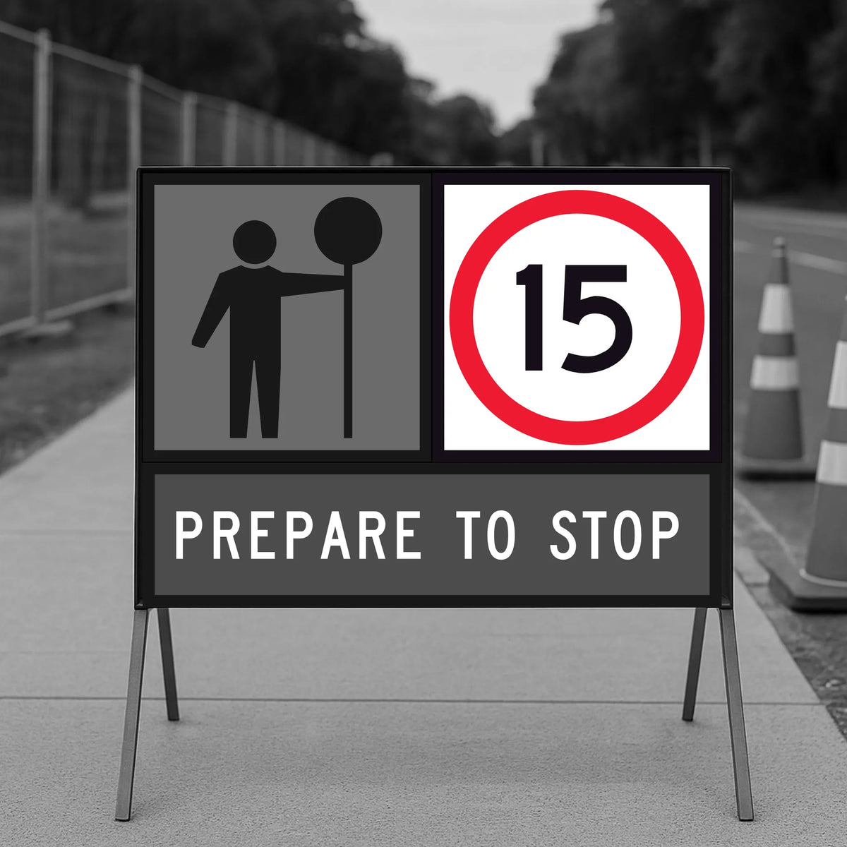 Temporary traffic road sign indicating a speed limit of 15 km/h on a road with traffic cones.