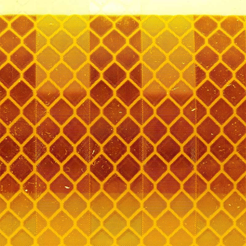 Close-up of the diamond pattern retroreflective surface of yellow Class 1 tape