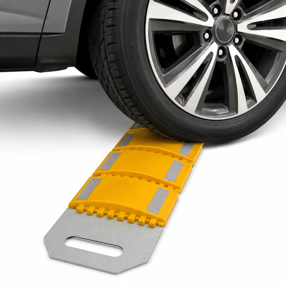 Vehicle tyre crossing the yellow rollout speed bump laid across the road surface