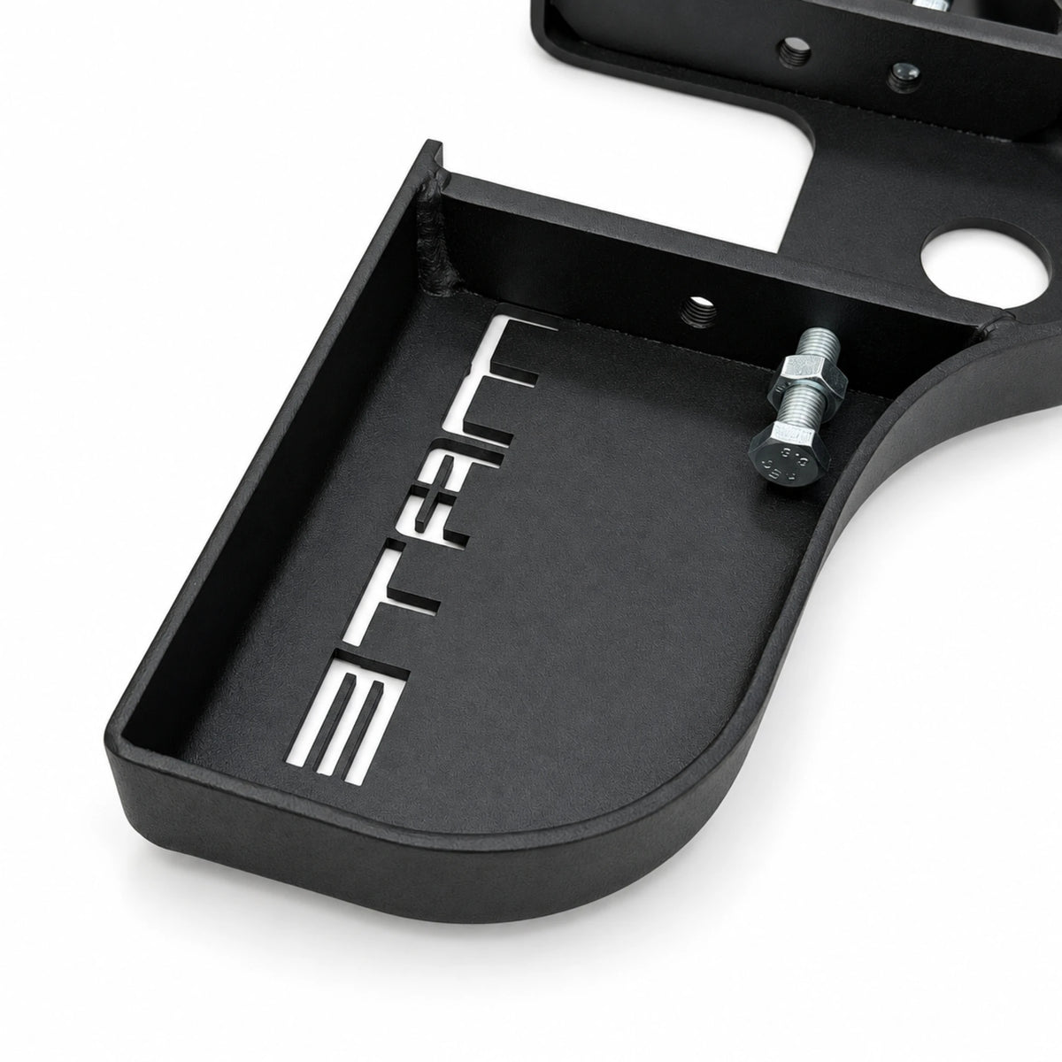 Close-up of an M10 locking bolt and nut in the side wall of the black Stepmate towbar step