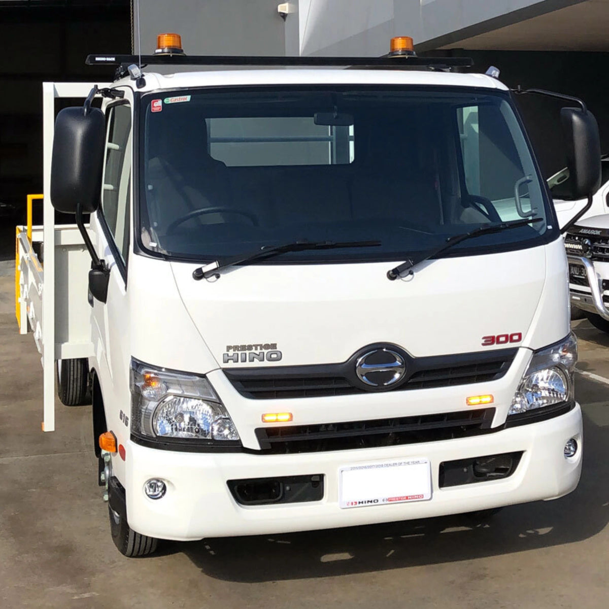 Two U30-12A amber light heads lit on the side of a white truck tray