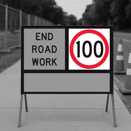 Temporary Traffic Road work sign with 'End Road Work' and a 100 km/h speed limit symbol on a sidewalk.