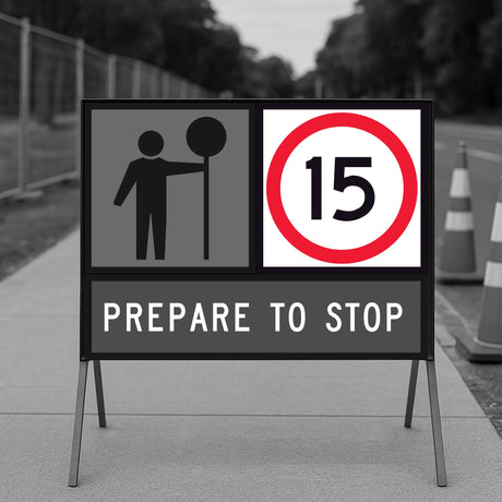 Temporary traffic road sign indicating a speed limit of 15 km/h on a road with traffic cones.