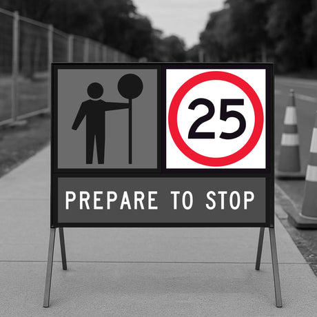 temporary traffic sign indicating a speed limit of 25km/h with traffic cones and barriers in the background.
