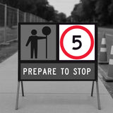 temporary traffic road sign indicating a stop ahead with a speed limit of 5 mph.