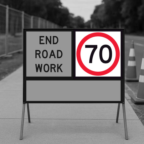 temporary traffic Roadwork sign indicating 'End Road Work' and a speed limit of 70 on a road with traffic cones.