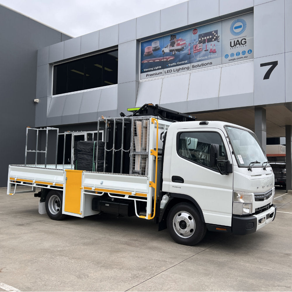 White tray truck fitted with traffic control racking outside the UAG Services building