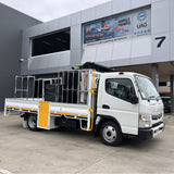 White tray truck fitted with traffic control racking outside the UAG Services building