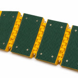 Underside of the rollout speed bump showing green grip pads screwed to the yellow hinged modules