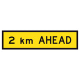 2 km Ahead TM1-36B 1200x300mm corflute sign panel with black 2 km AHEAD text and border on yellow retroreflective background
