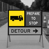 Traffic control sign with Detour sign with truck symbol and text 'Prepare to Stop' on a road.