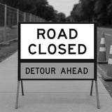 Road closed sign with roadwork information on a blurred background
