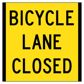 Yellow sign with black text 'BICYCLE LANE CLOSED' on a white background