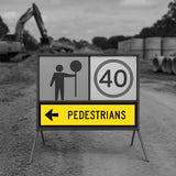 Temporary traffic control construction site with a pedestrian and speed limit sign.