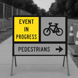 Sign indicating an event in progress with directions for pedestrians and cyclists.