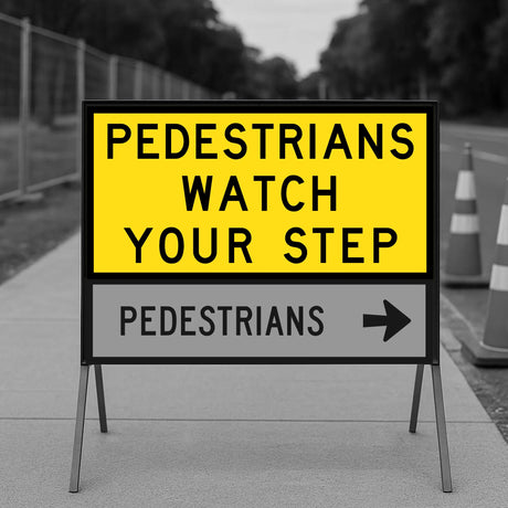 Warning sign for pedestrians to watch their step on a sidewalk.