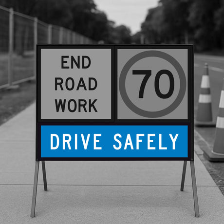 Roadwork sign indicating 'End Road Work' and 'Drive Safely' with a speed limit of 70 on a road background.