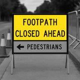 Yellow and black sign indicating 'Footpath Closed Ahead' with an arrow pointing left.