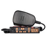 GME TX3100 super compact UHF CB radio with its black hand microphone resting on top, front three-quarter view