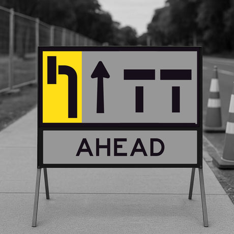 lane status road sign with directional arrows and 'AHEAD' text on a blurred background