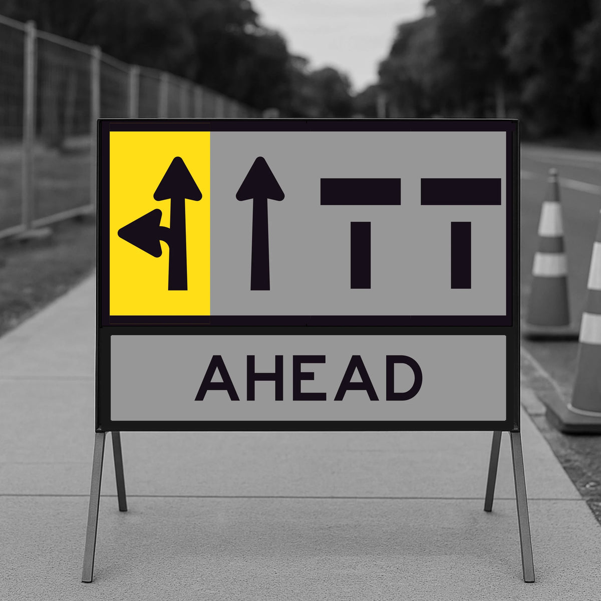Road sign with directional arrows and 'AHEAD' text on a blurred road background