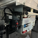 Close-up of a vehicle's undercarriage with heavy duty adjustable under tray battery tray for auxiliary battery mounting