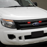 White Ford Ranger ute with two red E3 warning light heads fitted in the front grille and an amber strip light above, photographed from the front