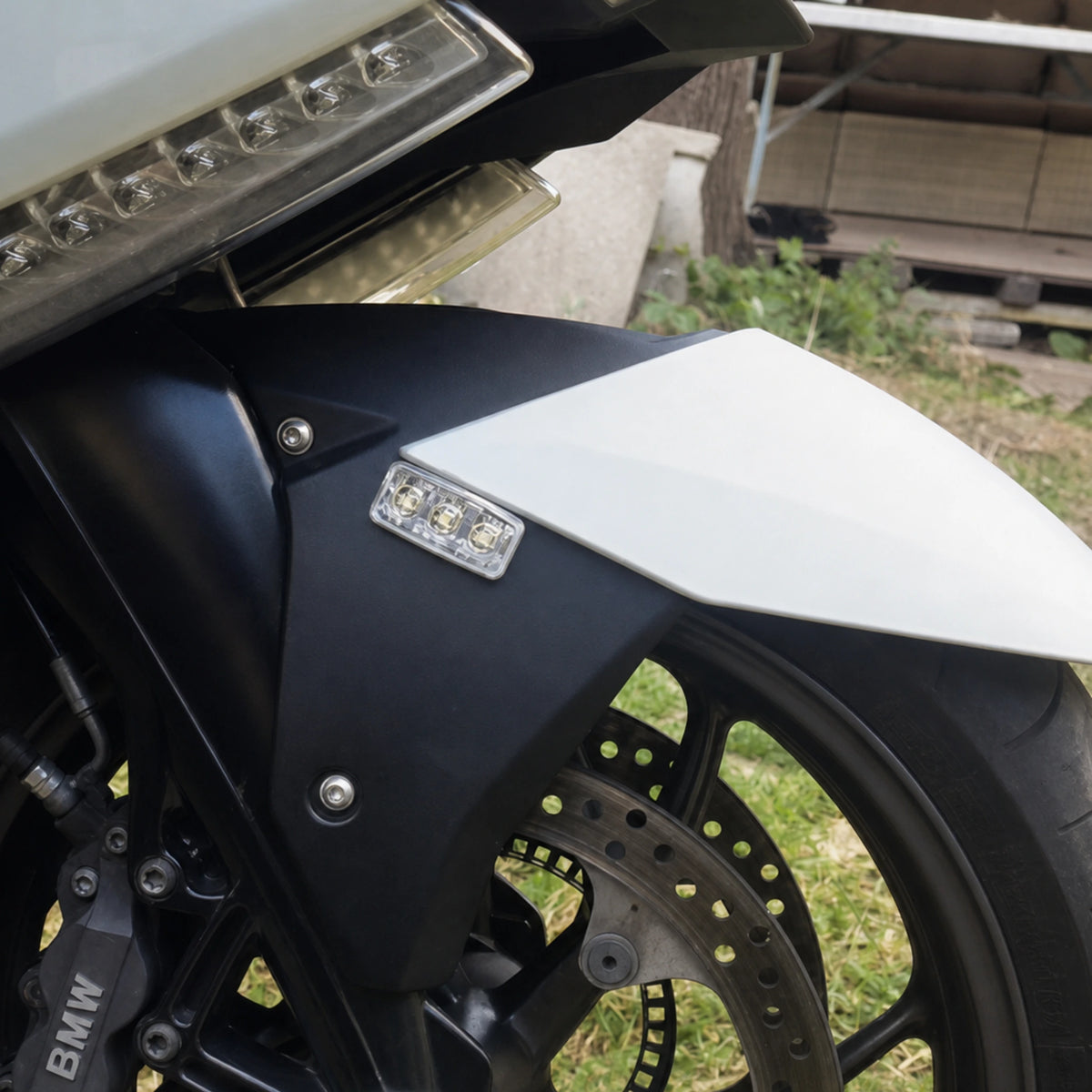 F3 LED warning light head fitted without the housing, stuck straight to a motorcycle mudguard with its 3M adhesive pad