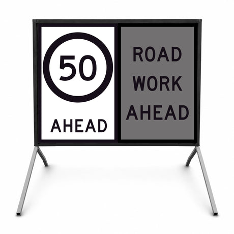 temporary traffic road sign with speed limit 50 ahead and road work ahead warning on a stand.