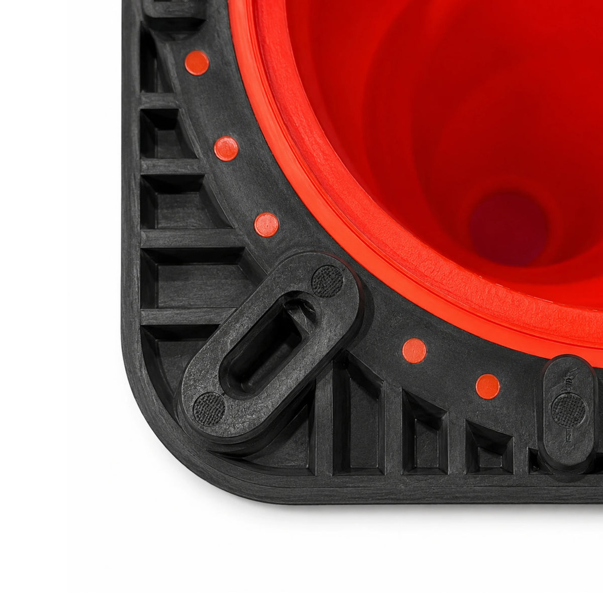 Underside corner of the traffic cone base showing ribbed black PVC construction and rubber foot pad