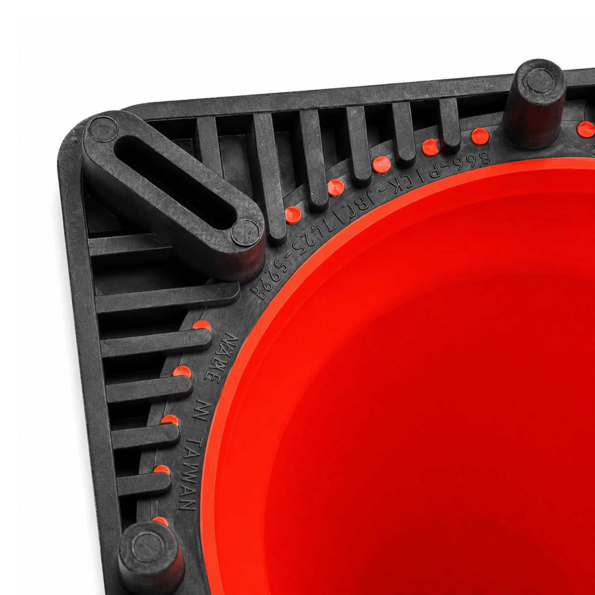 Top-down view of the cone base corner showing rubber feet, ribbed black PVC and moulded orange interlock studs
