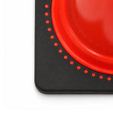Top-down corner detail of the black cone base with a row of orange interlock studs around the cone