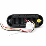 Rear view of the LED warning light head showing the ribbed aluminium base, a mounting hole at each end, the four core wiring loom and the factory model tag
