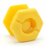 Two yellow hexagonal SupaGrip SafeKerb connector components, the front one showing the slotted socket opening