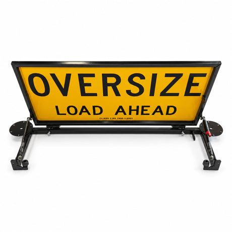Rear view of the raised double-sided Oversize Load Ahead sign showing the base frame and gas struts