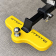 Safety yellow Stepmate towbar step fitted under a chrome tow ball on a tow bar tongue