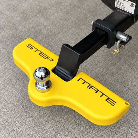 Safety yellow Stepmate towbar step fitted under a chrome tow ball on a tow bar tongue