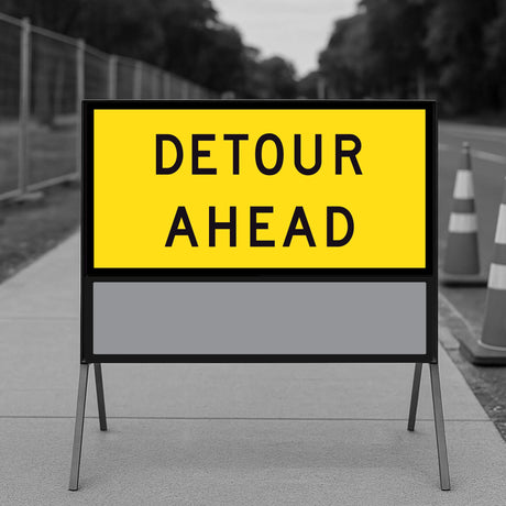 Detour Ahead TM1-6C 1200x600mm corflute panel filling the upper position of a multi-message sign frame with a blank panel below, on a footpath with traffic cones and temporary fencing
