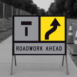 Lane Shifts Right TM10-16A corflute panel in a multi-message sign frame with a Lane Closed Ahead T symbol in the left-hand position and the shift arrow in the right-hand position, reading as the left lane closed ahead with the right lane shifting right, and a ROADWORK AHEAD panel below, on a footpath with traffic cones and temporary fencing