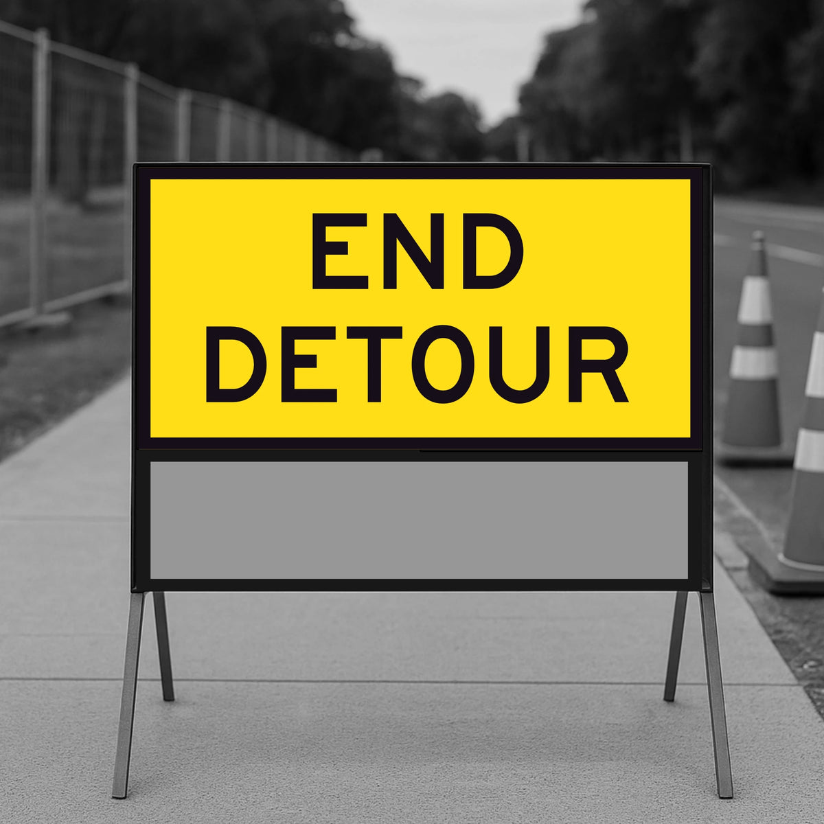 Yellow 'END DETOUR' sign on a stand with a blurred background