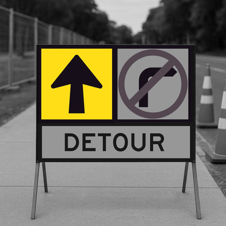 Detour sign with traffic direction and right turn prohibition symbols on a road.
