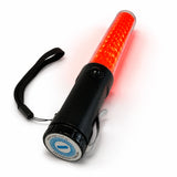 Red LED traffic marshalling wand glowing orange, with belt clip and UAG Services branded end-cap label