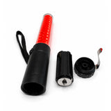 Red LED traffic marshalling wand disassembled, showing open battery compartment and removable end cap with belt clip