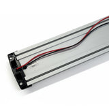 Back of the LED strip light showing the aluminium extrusion, 12V label and red and black wiring