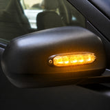 X6 18W LED warning light head fitted to a vehicle wing mirror housing, secured with two mounting screws, illuminated amber